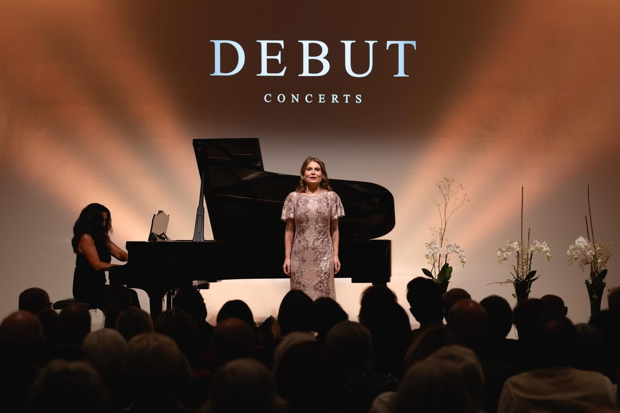 Karolina Bengtsson on stage at Debut Concerts, standing beside a grand piano